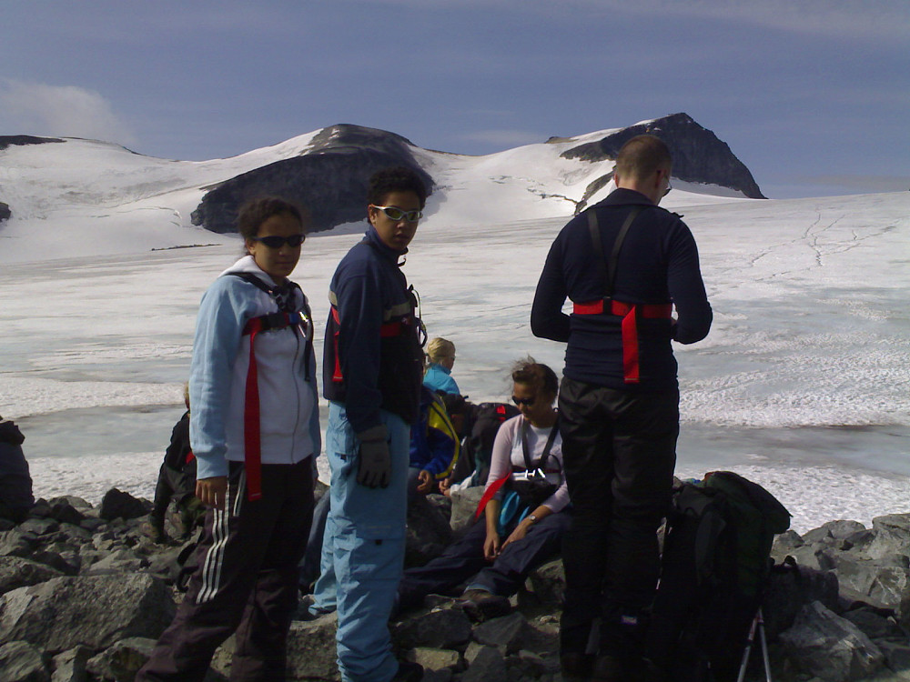 Image 1: My oldest daughter and my oldest son in front of Mount Galdhøpiggen and the glacier Styggebreen. The girl sitting is my youngest daughter. Her little brother is sitting beside her, though barely visible behind his older brother.