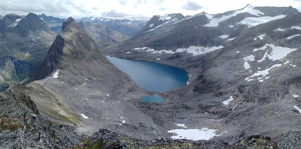 Image #16: Lake Bispevatnet as seen from the upper parts of Mount Kongen. To the left of the lake is seen Mount Bispen, to the right is Mount Finnan, and in the distance is seen Mount Alnestinden.