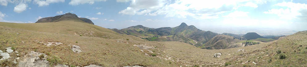 #13: A panorama showing the volcano-like appearance of the mountain. The Wochecha summit is seen to the left. Moglē Korebta is just to the right of the middle of the image.