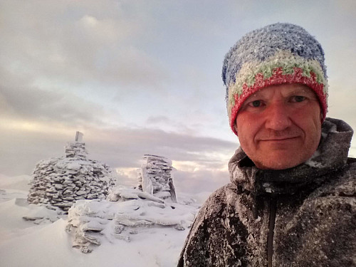 At the summit of Mount Tverrfjellet on the Sula Island. Behind me are the two largest cairns on this mountain.