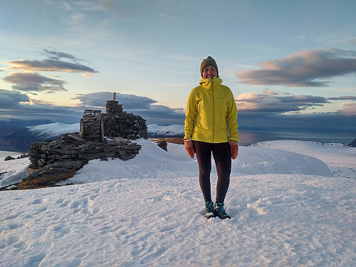 My daughter Vår on the summit of Mount Sulafjellet, in front of the two largest cairns that have been built up there.