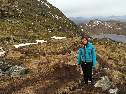 My daughter Sol as we're approaching the summit of Mount Storhornet on Godøy Island. Lake Alnesvatnet and Mount Lesten are seen in the background.