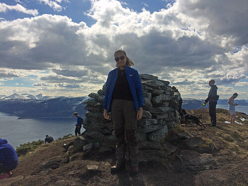 My daughter Vår in front of the cairn at the summit of Mount Storhornet.