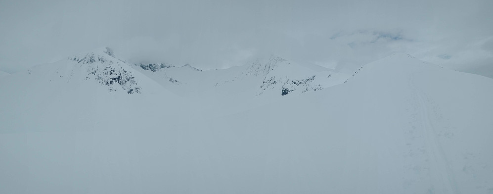 #1: Image captured while upon the mountain ridge called Steinberget. The mountain to the left is Mount Klauva (1512 m.a.m.s.l.), and the one to the right is Kyrkjetaket (1439 m.a.m.s.l.) [i.e. "The Church Roof]. The two mountains are part of a horse-shoe shaped mountain ridge called "The Horse Shoe Traverse". There are people that have gone the entire Horse Shoe Traverse on ski, but I wouldn't even think of an attempt in this weather.