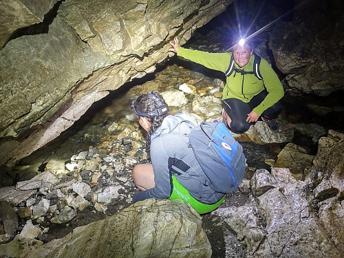 Image #7: My daughter and her aunt are studying how the river have been carving itself a passage beneath the wall of the cave.