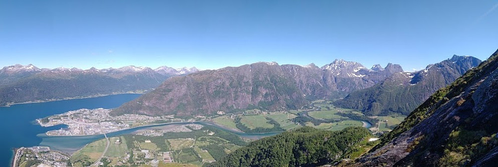 Image #1: View towards the town of Åndalsnes and mountain range called Romsdalseggen. In the foreground the Rauma valley with the Rauma river is seen.