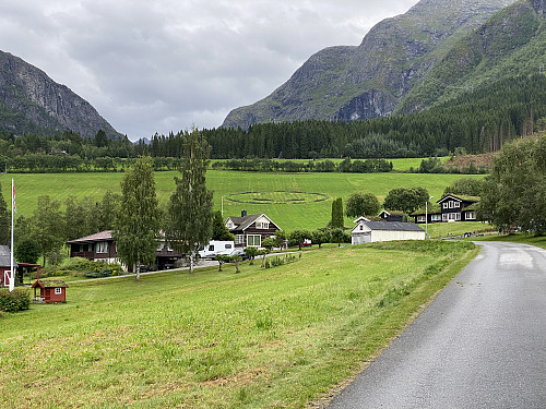 Image #1: The valley between Mount Haugabotstinden (to the right) and Mount Svartebotstinden (to the left) as seen from the village by the fjord of Innfjorden. One of the farmers in the village had made a "smiley" when cutting his grass this year.
