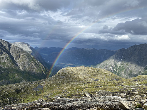 Image #24: A beautiful rainbow behind me as I was hiking towards the summit of Mount Karihaugen. The mountain range called Romsdalseggen is seen in the background.