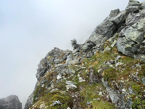 Image #20: This part of the trail is marked by small cairns that might help you find your way. Nevertheless, in foggy weather like this, I would advocate that you make the trip with someone familiar with the route. Again, the shelves make the trek quite feasible, but you need to mind your step, as the cliff to the left is quite steep.