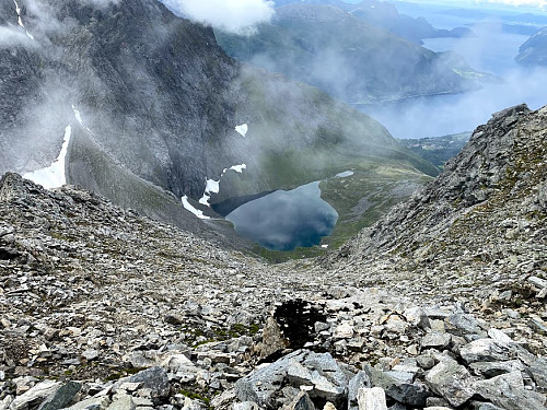 Image #23: Looking down the same chute as on the previous image, i.e. into the valley called Haugabotnen with a little lake called Haugabotsvatnet. The fjord in the background is called Innfjorden.