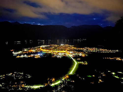 Image #44: The town of Åndalsnes by night, as seen from a viewpoint about 300 meters up the ridge of Mount Setnesfjellet.