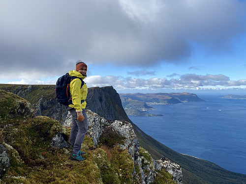 Image #8: My daughter on top of Mount Klovetinden. The mountain behind her is Mount Masdalshornet, and the large island in the background is the one called Hareidlandet Island.