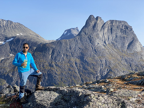 Image #4: Having a short brake with something to drink on Mount Norafjellet. View towards Mount Romsdalshornet, Mount Lillehornet, and Mount Hornaksla. The mountain behind Mount Romsdalshornet is Mount Kalskråtinden.