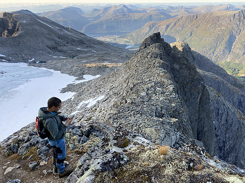Image #11: On top of Mount Nordre Trolltinden, looking down at Mount Middagsbarna and Mount Adelsfjellet. The town of Åndalsnes is seen afar in the background.