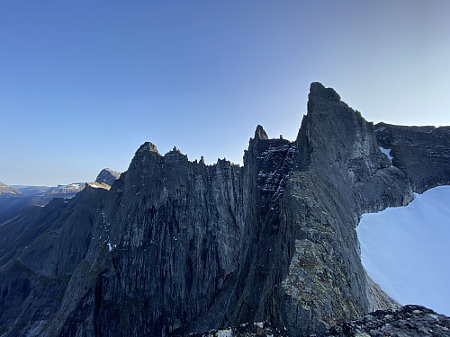 Image #14: The mountain ridge from Mount Nordre Trolltinden to Mount Store Trolltinden. The Troll Wall is seen to the left of the ridge, and Adelsbreen Glacier is seen to the right of it.