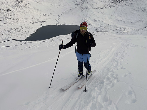 Image #9: My son in the ski trail ascending Mount Alnestinden. Lake Alnesvatnet is seen on the other side of the road from which we started out.
