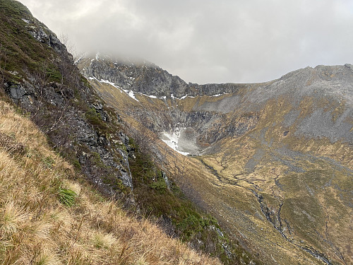 Image #5: View from the mountain side of Mount Vallahornet into the valley of Skytedalen. Beyond the valley Mount Saudehornet is seen, reaching into the clouds.