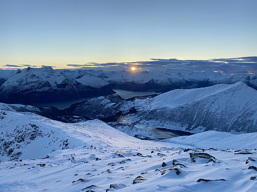 Image #3: Sunset arrives early during winter at this northern latitude. View from the summit area of Mount Smørbottinden.