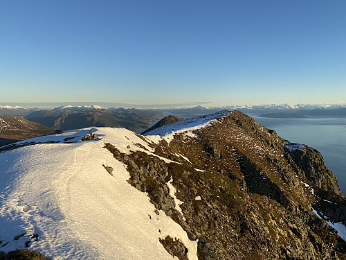 Image #10: View from the summit Mount Opdstadhornet along the east ridge of the same mountain. The peak without snow behind the ridge, is Mount Heggdalshornet.