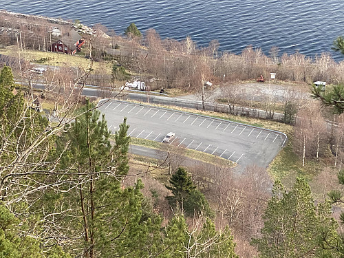 Image #16: View of the parking lot by Nord-Heggdal Chapel, as we were descending through the forest down the steep mountainside towards it.