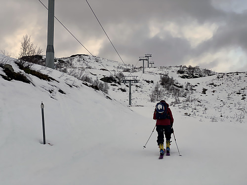 Image #3: My daughter on her way upwards along the path of the ski lift. Snow was scarce, but sufficient where it had been been previously groomed by a snowcat.