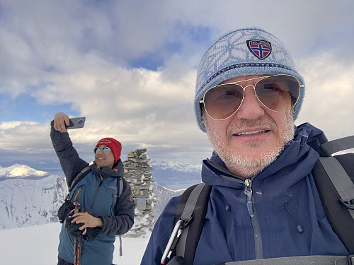 Image #13: "Selfies" being secured by the cairn on top of the mountain. Romsdalsfjorden Fjord is seen in the background, and Mount Skjervan [1545 m.a.m.s.l.] is partly visible behind my son.