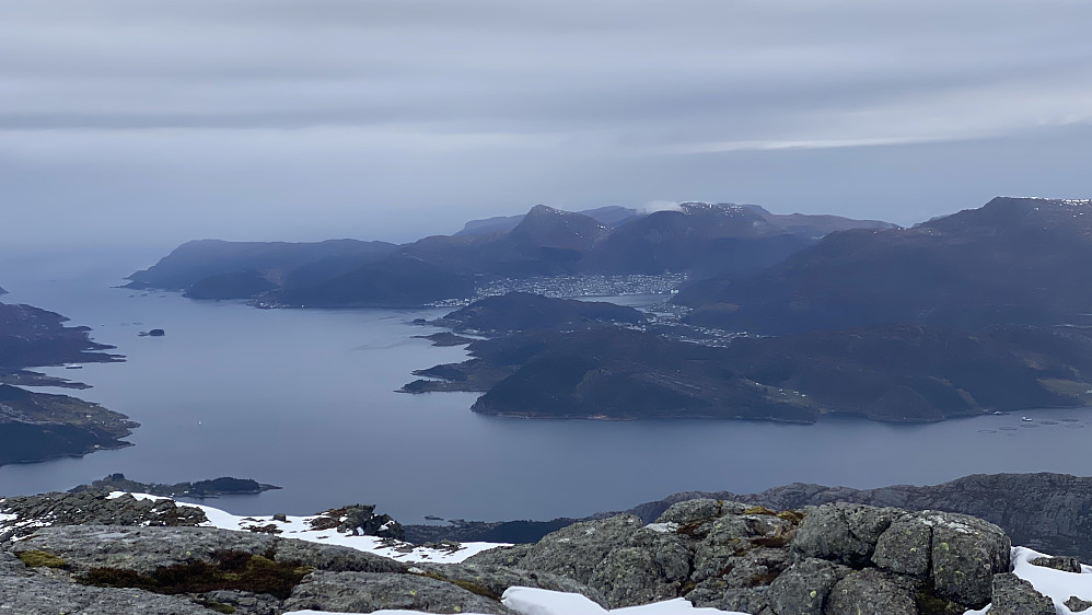 Image #19: View from Mount Hornelen towards the town of Måløy, by the fjord of Vågsfjorden. The town is located on the island of Vågsøy. Behind it are seen the mountains of Brurahornet [604 m.a.m.s.l.] and Veten [613 m.a.m.s.l.].