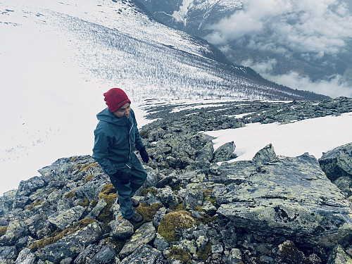 Image #6: Climbing up the snow-free part of the ridge towards the summit. It's a bit exhausting to jump from stone to stone, but still easier than wading through deep snow.