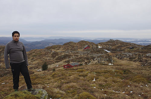 Image #9: View towards a little pond, surrounded by the mountain cabins of Årstadvoll, Djervhytten and Breidablikk. On the hill beyond the pond, is located a cabin called Stormfuglen.