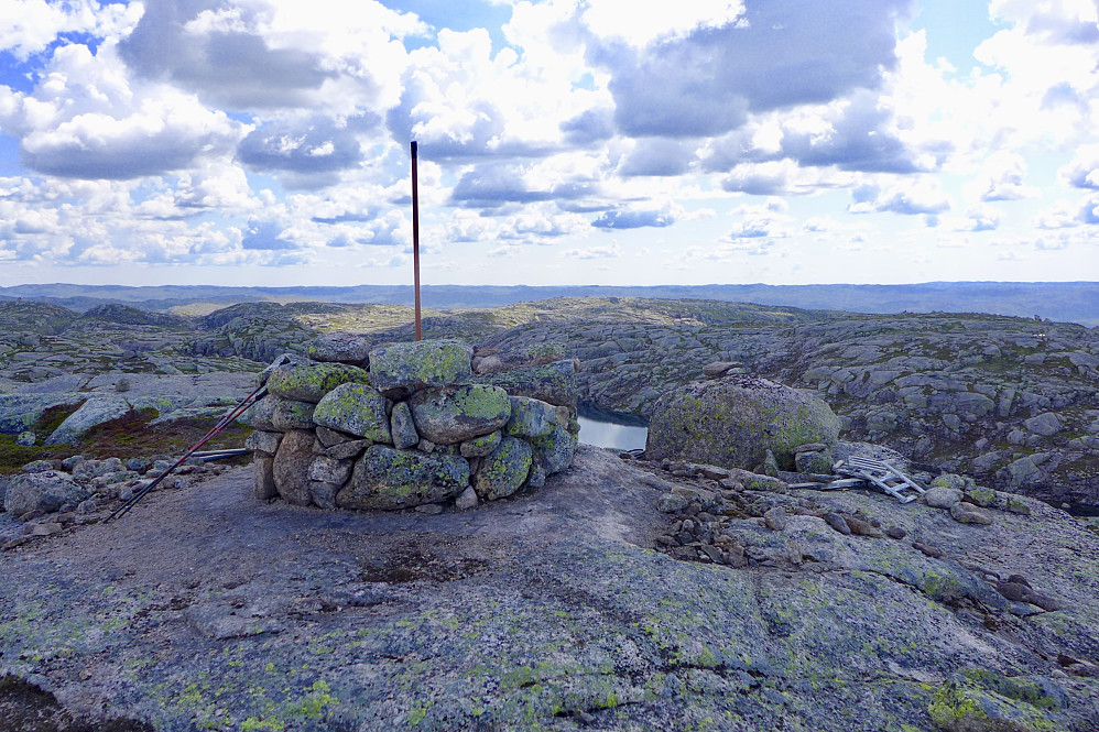 Restene etter den sirkulære, nedrevne varden på Nordre Grubba. Litt av trevirket fra trig-merket sees også