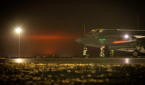 Norske F-35 stasjonert på Island. Rødglødende lys fra vulkanen sees i bakgrunnen