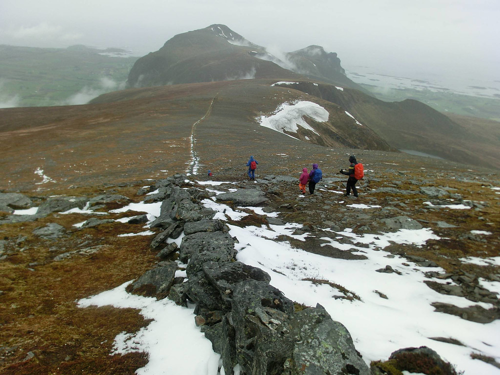 Så går turen over fjellryggen over til Sjurvarden på andre siden. Legg merke til steingjerdet som går langs ryggen. Ingen vet riktig hva som er grunnen til det lave gjerde. Grense er mest nærlignede..