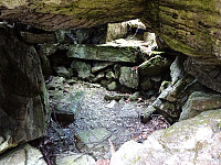 The little (and low!) "room" underneath a big rock that apparently served as secret weapon storage during WWII.