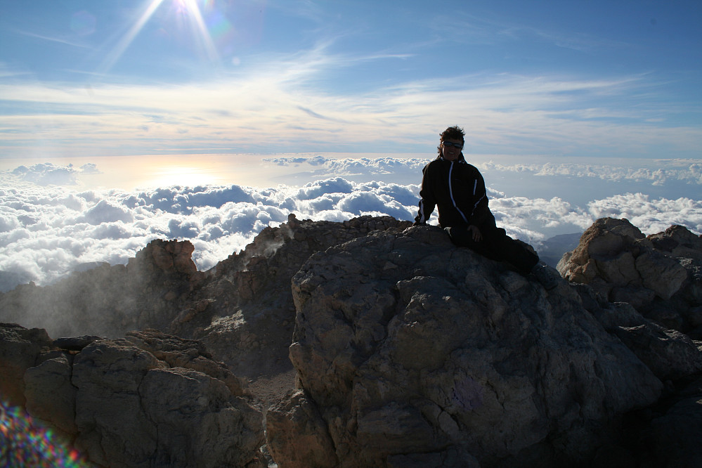 Bente posing at the very top of Spain. Note slight curvature of Atlantic Ocean behind! To the left in summit crater easily visible sulphuric fumes emerging from cracks and fissures. 