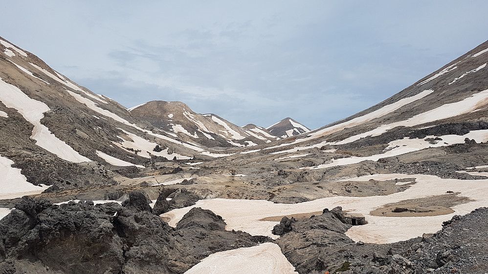 Heading north, app. 1760m asl. Trail(and dirt road) turning to the left beyond partly snow-covered flank to the left. Western flank of Mount Kakovoli 2214m asl rising to the right