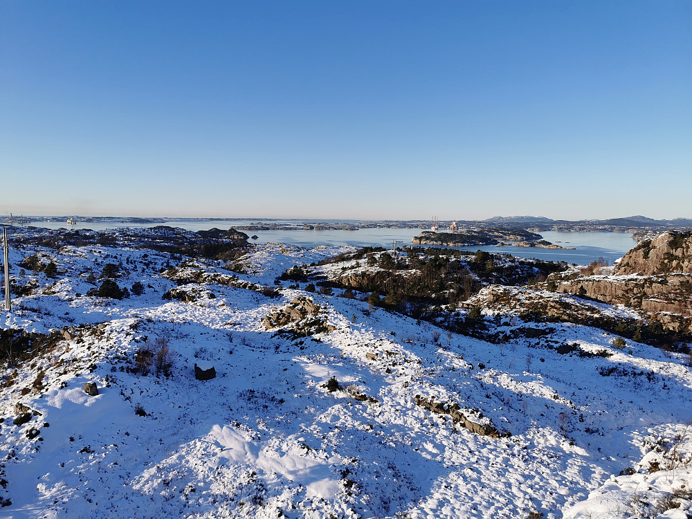 Utsikt nordvestover, bl.a mot en speilblank Hjeltefjord. Eldsfjellet markert i nord. 