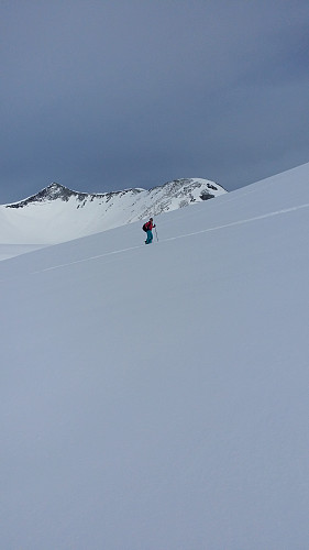 Kari Anne på vei opp på Gråfjellet. Trolltind - massivet i bakgrunnen.