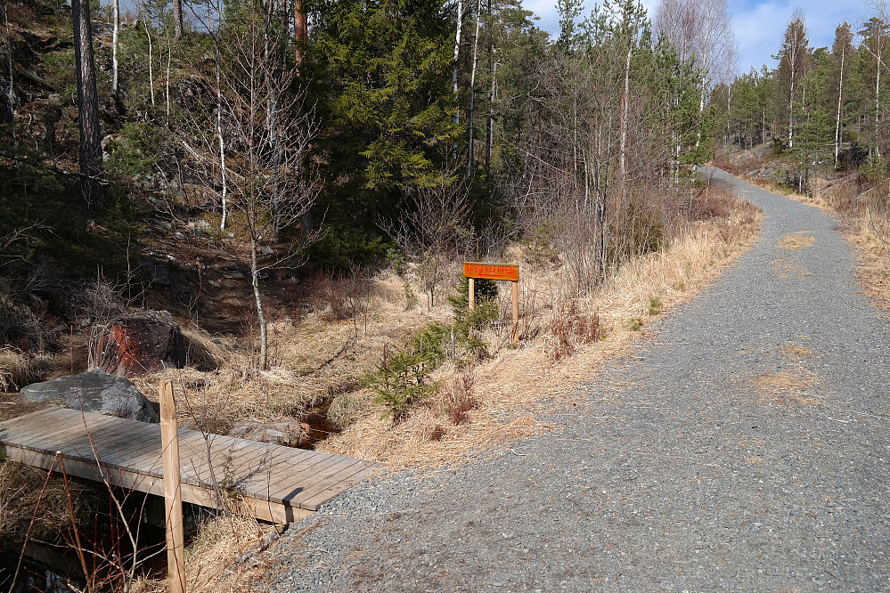 Stidelet litt nord for parkeringsplassen. Over kloppen nede til venstre i bildet går hovedstien til Linnekleppen (325). Skiltet midt i bildet peker også den veien. Alternativ rute til Linnekleppen går videre på grusveien til høyre, som altså er den østre veien til toppen, og der jeg gikk mot Linnekleppen.