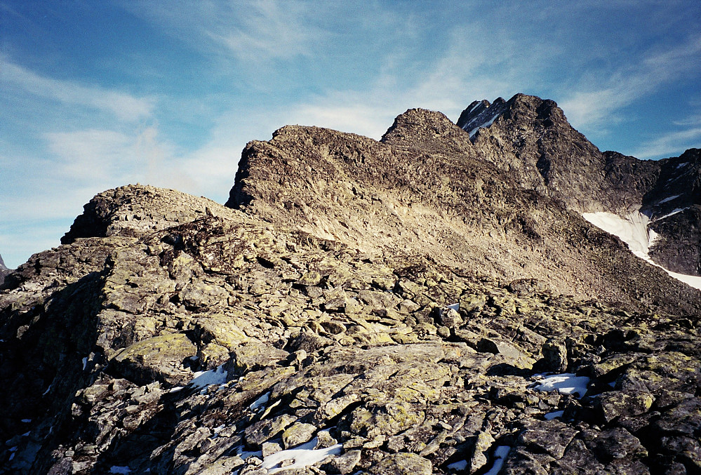 21.09.1996 - Austanbotntindane sett fra vestryggen. Midt i bildet er Vestraste Austanbotntinden (2020). Til høyre for den er så Vestre Austanbotntinden (2100), og litt mer til høyre Store Austanbotntinden (2204), med sine 3 pukler. Lokkende rygg sett fra vest! Kort anmarsj, med et par lette topper før det for alvor blir luftig. Toppvarden på Store (2204) ses så vidt på kulen bakerst (den til venstre). Zoomer man max inn, vil den observante se 2 bittesmå skygger/prikker litt til høyre for toppvarden. Dette er de 2 klatrerne vi møtte da vi kom til Vestre Austanbotntinden (2100). 