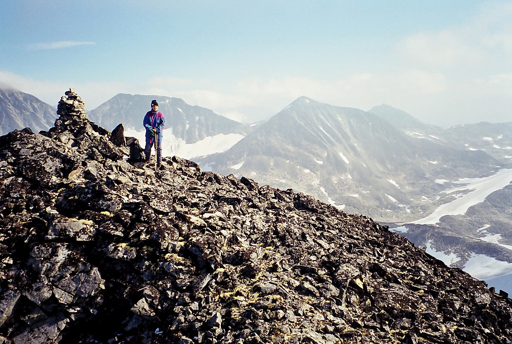 11.09.1999 - Ved toppvarden på Semelholstinden (2147). Utsikt mot øst. Rett bak Grete er Nestsøre Hellstugutinden (2255). Litt til høyre i bildet ses Søre Hellstugutinden (2189).