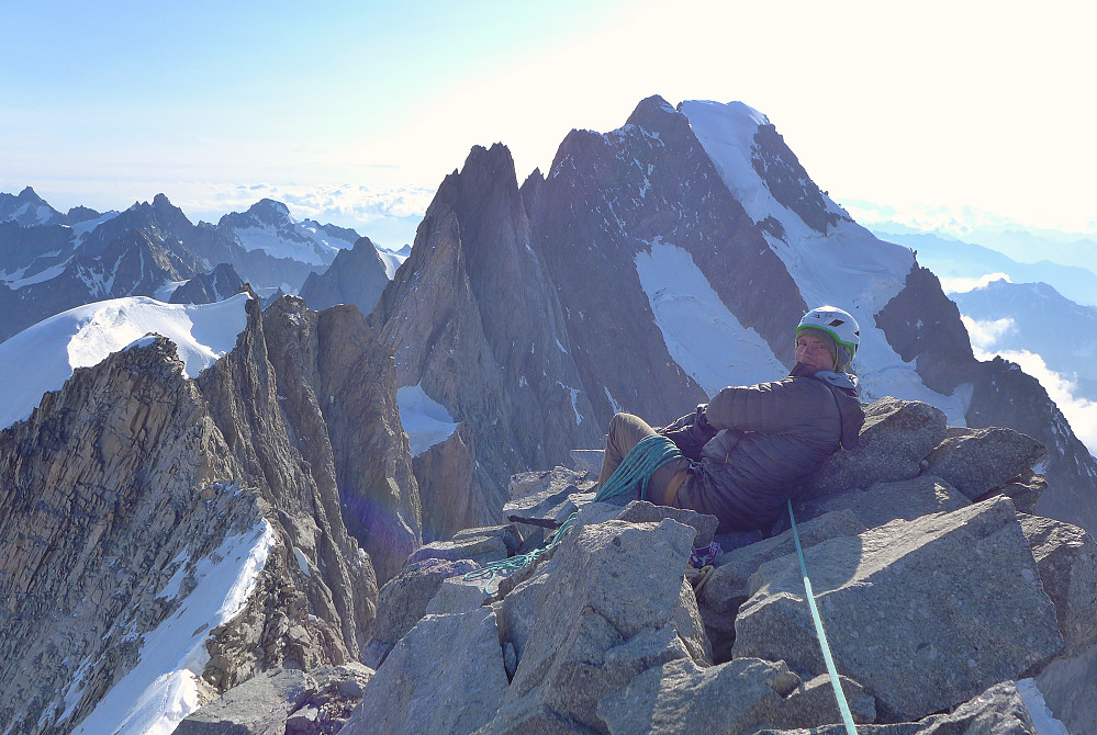 Tim sitting on summit number 2 with the magnificent Grandes Jorasses behind