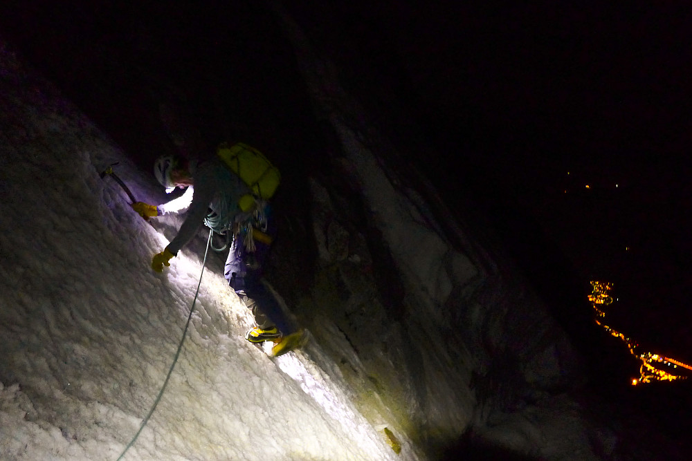 Icy traverse between the Rocher du Reposoir and the Rocher Whymper. Courmayeur lit up in the valley bottom.