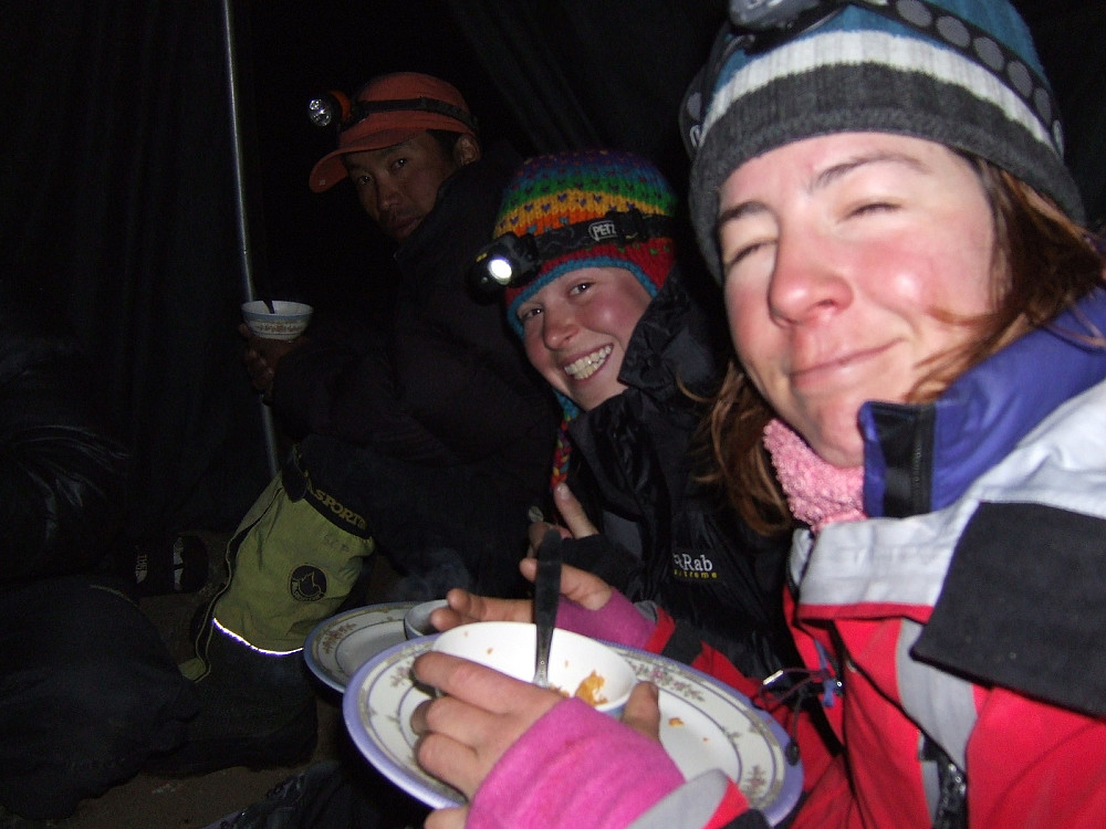 In the mess tent at base camp, the night before the ascent of Lobuche East. Smiles all round from Alys and Rocio