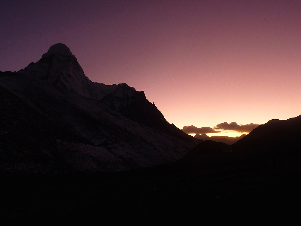 Ama Dablam casts a distinctive silhouette against the sky at sunset