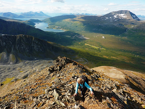Terese on the approach to Middags-aksla, Ramfjord and Tromsdalstinden in the background