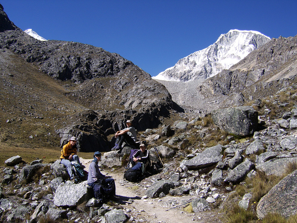On the walk up to Laguna Ishinca from base camp|center
[[image:hmsv1_peru_july_2005835.jpg|Ranrapalca|center
[[image:hmsv1_peru_july_2005837.jpg|View towards Urus from Laguna Ishinca|center
[[image:hmsv1_peru_july_2005838.jpg|Beneath Ishinca|center
The trail was well-sign-posted, and we took a decent break after about only 40 minutes of walking. After that we walked up to the next “rest” stop at a flat, sandy spot where a number of paths appeared to merge at that junction. We weren’t far from the lake now – about 100-150m in height, and eventually reached the lake after more ascent over the dry, stony path at about 11am. Here we got excellent views of Ishinca and the comparative beast-of-a-mountain next to it, Ranrapalca. It was also an ideal place to have a much-deserved snack break and sit around lazily in the sunshine for another good 40 minutes. Dinner was the usual course of soup followed by some sort of meat casserole and rice. Bedtime at 8pm.
[[image:hmsv1_laguna-ishinca.jpg|Panorama from Laguna Ishinca