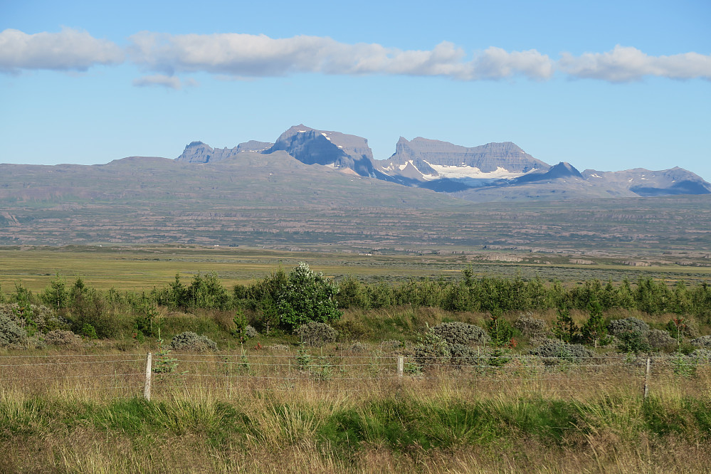 Dyrfjöll seen from west. Dyrfjallstindur to the left, Ytra-Dyrfjall (Súla) in the middle and Heimra-Dyrfjöll to the right of Dyr (the door).