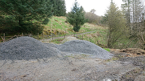 Small parking lot filled with heaps of gravel